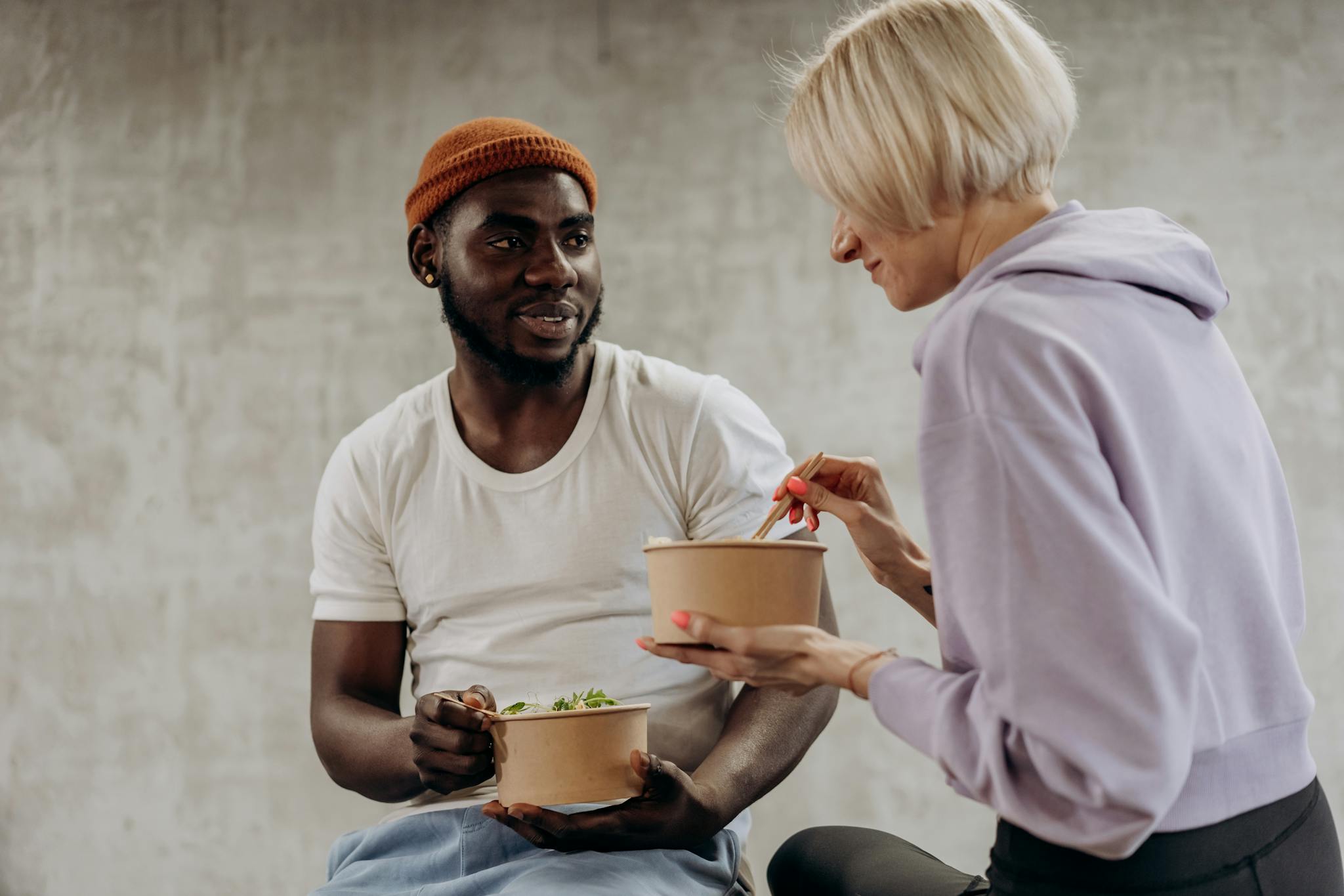 Two friends enjoying a healthy meal together, promoting nutrition and well-being.